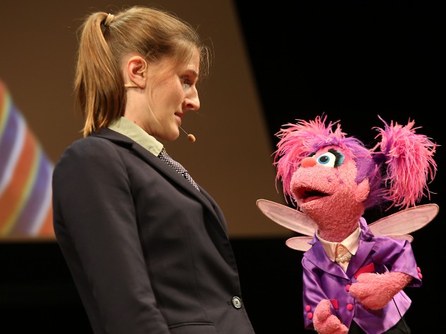 Muppet Abby Cadabby sings with a member of Hasty Pudding Theatricals.