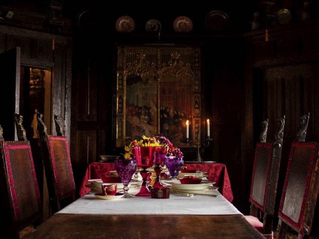 A Gothic-style dining room, with the table set for a formal dinner