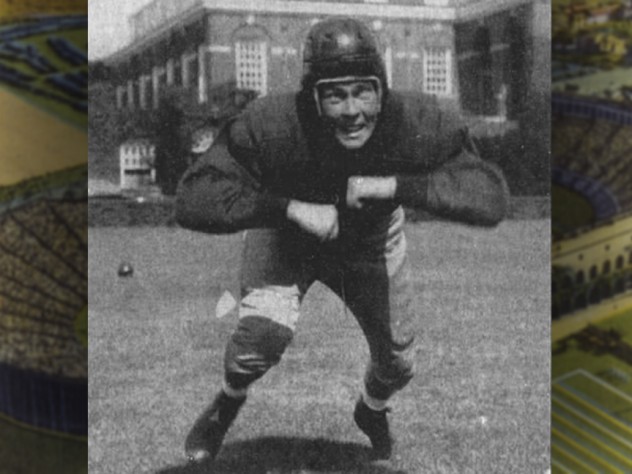 Football player Chubb Peabody, in pads and helmet, charges forward.