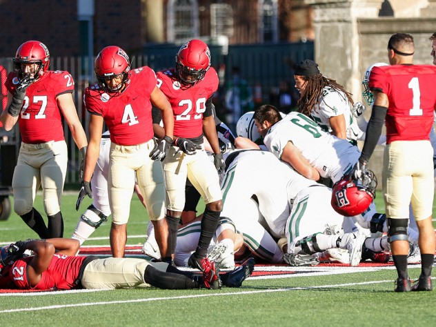 Dartmouth players jubilantly pile on Masaki Aerts after a last-second victory.