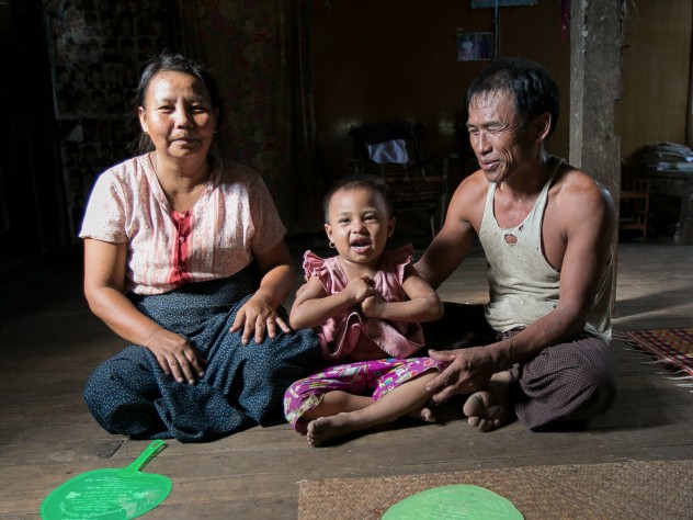 Photograph © Tim Mitzman for Proximity Designs 2013 U Myat Thein, an entrepreneurial farmer and now a village agent for Proximity Designs, grows corn as a cash crop in Wakouktaw village, Kungyangon township; with his wife, Daw Khin Ohn Myint, and their youngest child, daughter Thin Thin Myat, he welcomes visitors to their home—fans at the ready for the delta's heat and humidity.
