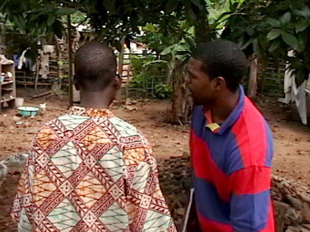 Courtesy of Sangu Delle Sangu Delle and Darryl Finkton conducting household visits to test drinking water, deliver information about clean water and sanitation, and let residents know about Project ACWA’s household latrine program.