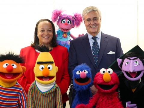 Harvard education dean Bridget Terry Long and Sesame Workshop CEO Jeffrey Dunn with a group of Muppets