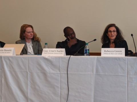Photo of three speakers seated at a table