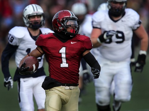 Andrew Fischer in runs up field with ball