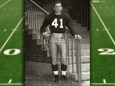 Carroll Lowenstein standing at the base of staircase