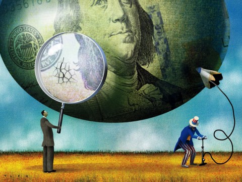 Cracks appear in a balloon decorated like a $100 bill as Uncle Sam fills it with a bicycle pump