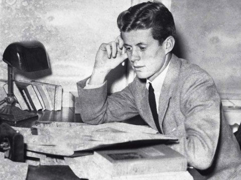 Archival photograph of John F. Kennedy as an undergraduate, circa 1939, studying papers