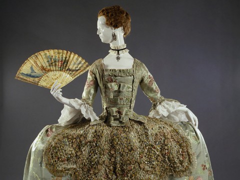 Ornate eighteenth-century dress with wide hooped skirt