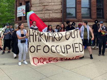 sign reading "Harvard out of occupied Palestine"