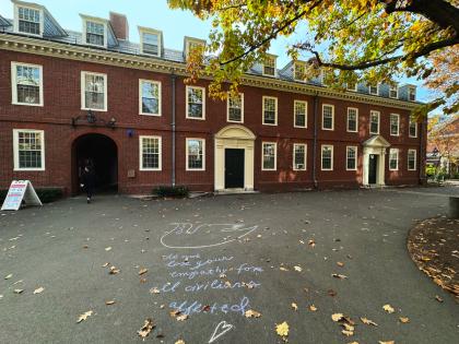 Harvard Yard with a message drawn in chalk on the ground 