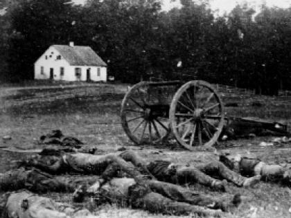 Dead Confederate artillerymen grouped near one of their limbers after Antietam. In the background is a Dunker church, built by a German Baptist pacifist sect.