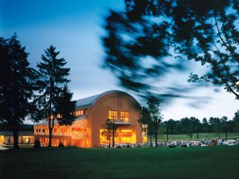 Seiji Ozawa Hall at Tanglewood, the summer home of the Boston Symphony Orchestra, in Lenox, Massachusetts. The hall opened in 1994. With the &ldquo;barn door&rdquo; open, picnickers enjoy a concert.