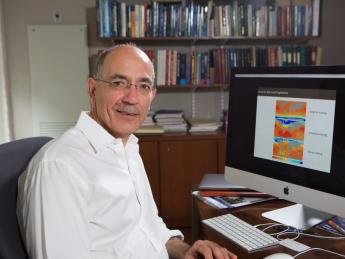A portrait of Jerry Mitrovica at his desk