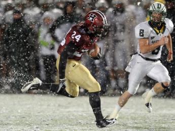 With wet snow veiling the Stadium's FieldTurf surface, tailback Treavor Scales '13 had his best game of the season against Dartmouth, rushing for 139 yards and two touchdowns. Cornerback Shawn Abuhoff is the Big Green defender.