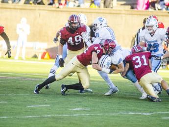 Not going anywhere? Columbia's Turner DeMuth ran into a posse of Harvard tacklers, including linebacker Eric Medes ’16 (number 49), defensive back Scott Peters ’16 (44), defensive back Jordan Becerra ’16 (31) and linebacker Chase Guillory ’18 (45).