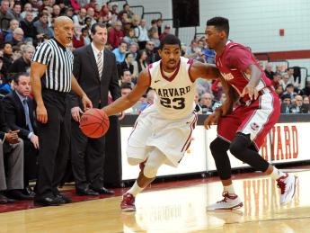 Senior Wesley Saunders (shown here, driving to the basket) led Harvard to victory with a game-high 27 points.