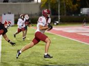 Harvard player #81 runs with the ball towards the end zone with Cornell player #9 in pursuit