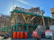 Construction site of a wood building that is two stories 