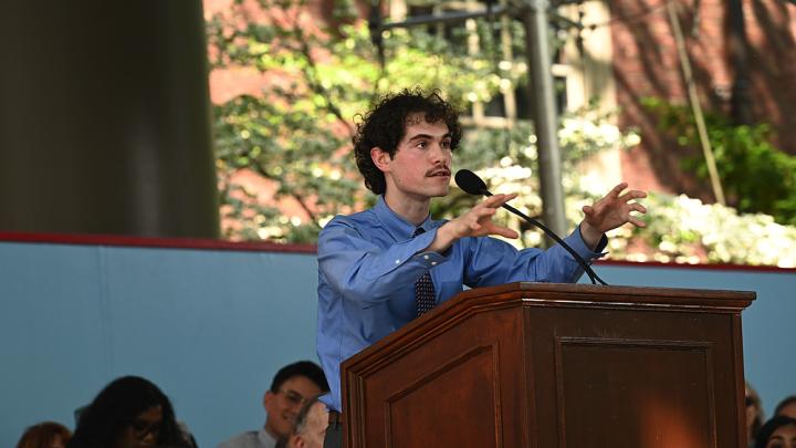 Man at podium addressing audience