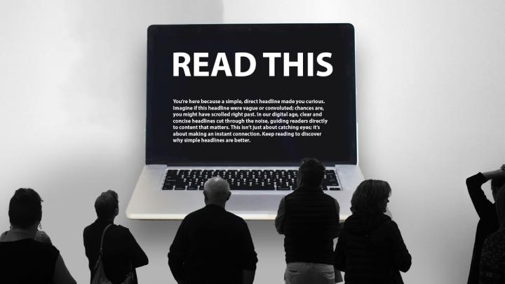 Five people, viewed from behind, are standing in front of a large, wall-mounted laptop screen displaying the text 'READ THIS' in a large, white font on a black background. 