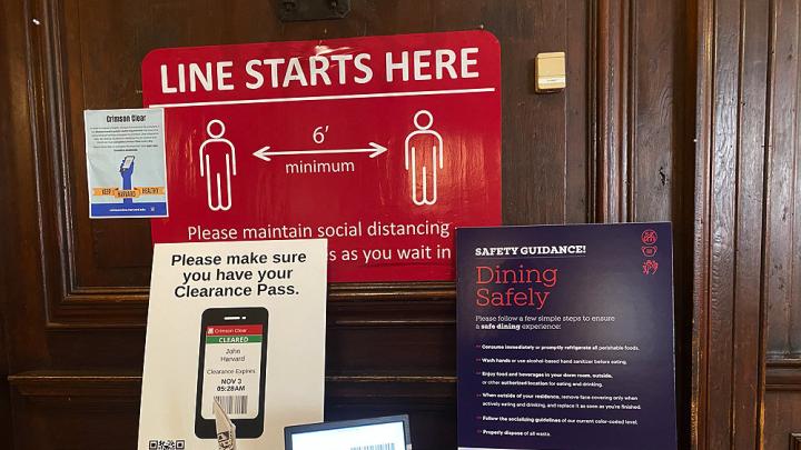 Signs outside the dormitory dining hall specifying rules for access and the need for social distancing.