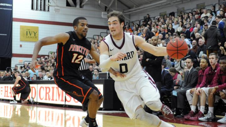 Senior captain Laurent Rivard drives past Princeton's Ben Hazel at Lavietes Pavilion. The Crimson swept both the Penn and Princeton home-and-away series this year for the first time in history.