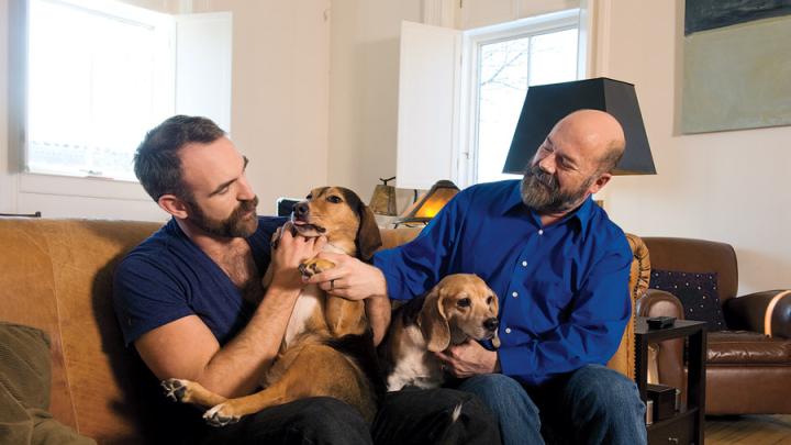 Sullivan (right)  at home with his husband, actor Aaron Tone, and their  two beagles