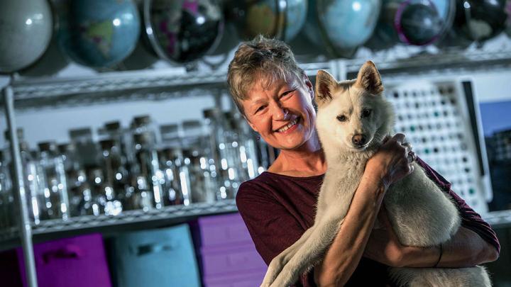 Linnea Olson, shown with her dog, Kumo, has survived 13 years with lung cancer.