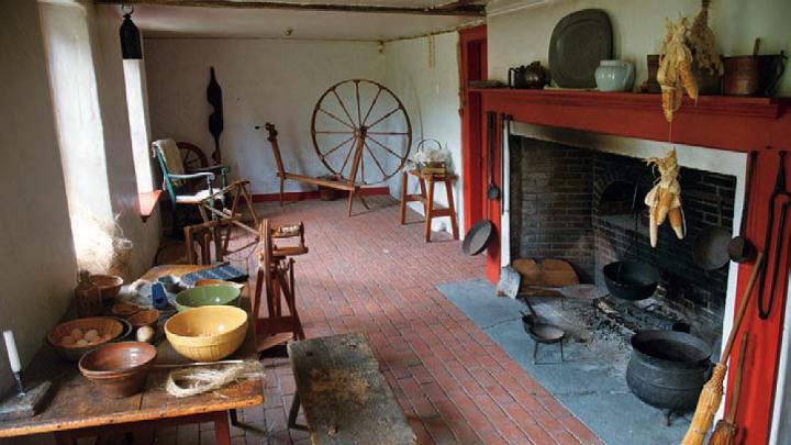 Open hearth, spinning wheel, and other elements in the colonial-era Sylvanus Brown House in Pawtucket, Rhode Island