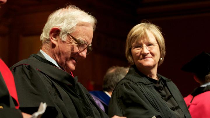President emeritus Derek Bok—finally invited to speak at this, his twenty-second PBK ceremony—checks the text of his oration; President Drew Faust is seated beside her predecessor. 