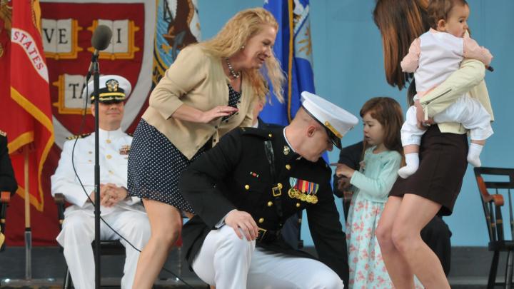 Second Lieutenant Taylor Evans, already a veteran of five years in the Marine Corps before entering Harvard, has his officer's insignia pinned on by his family.