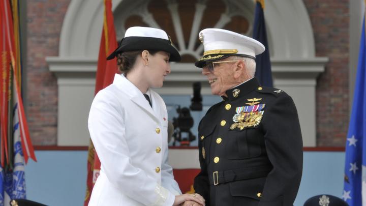Ensign Catherine Philbin is congratulated by Colonel Bruce Martin, USMC (ret), who administered her oath of office.