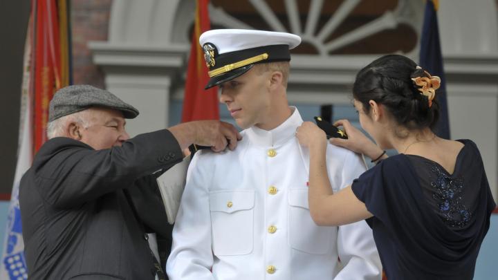 Ensign Christopher Curtis receives his new insignia.