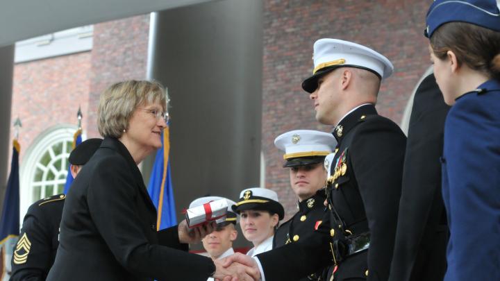 President Faust congratulates the officer candidates. She gave each of them a copy of <i>The Sleepwalkers: How Europe Went to War in 1914.</i>