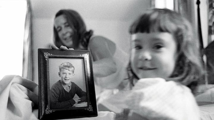 Eve, foreground, and her grandmother, with a fifth-grade photo of Geoffrey