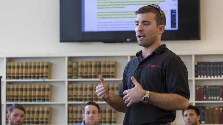 Program director Logan Leslie ’16, a veteran of the Special Operations Forces and member of the National Guard, leads a seminar during the WSP course. The project, which debuted at Yale University in 2012, expanded to Harvard and the University of Michigan this year.