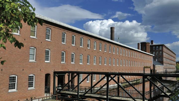 an exterior view of the mill and one of the canals constructed to divert river water to power its machinery