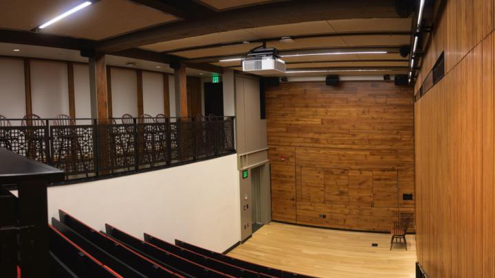 A tiered, downward-sloped theatre with 64 seats