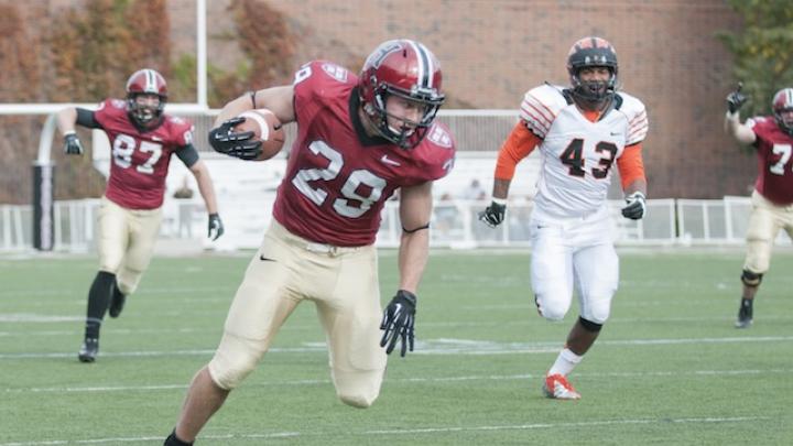 Halfback Paul Stanton Jr. (29) led the rushing attack against Princeton, carrying 12 times for 91 yards and two touchdowns. His first score came on a 60-yard breakaway that helped Harvard to a 14-13 lead in the game’s second quarter. The pursuing Tiger is linebacker Jason Ray.