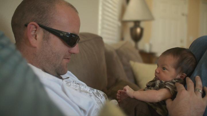 One of the veterans, home from Pathway, cares for his newborn. 